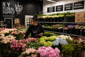 Wedding florist selecting wholesale flowers including imported roses, peonies, hydrangea, and specialty blooms inside a professional floral warehouse at NY Floral Supply in Farmingdale, NY.